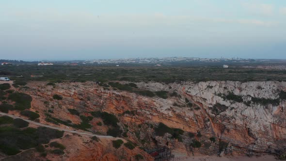 Scenic Aerial View of Secluded Beach Hidden Between Rocky Colorful Cliffs in Lagos Algarve Portugal alt