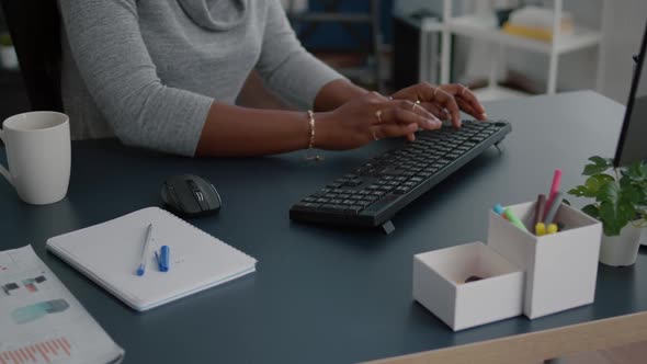 Closeup of Student with Black Skin Hands Typing on Keyboard Searching Information alt