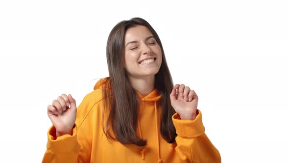 Slowmotion Excited Carefree Happy Adorable Feminine Woman in Orange Hoodie Dancing Enjoying Party alt