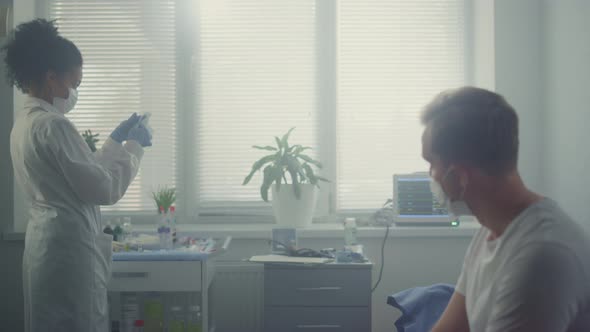 Nurse Making Covid Vaccination for Patient Sitting Hospital Cabinet Close Up alt