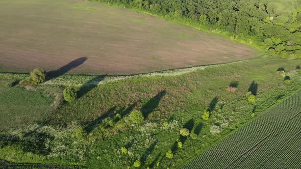 Aerial Shot of Big Rubbish Pile Lying Among Field in Countryside