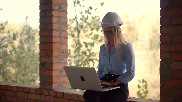 Woman Architect In Helmet Inspecting Building. Designer On Construction Site. Builder Contractor. alt