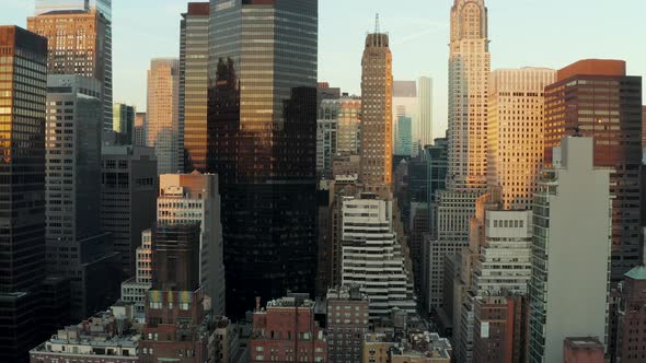 Modern High Rise Buildings with Glossy Glass Facades Reflecting Colourful Sunset Sky alt
