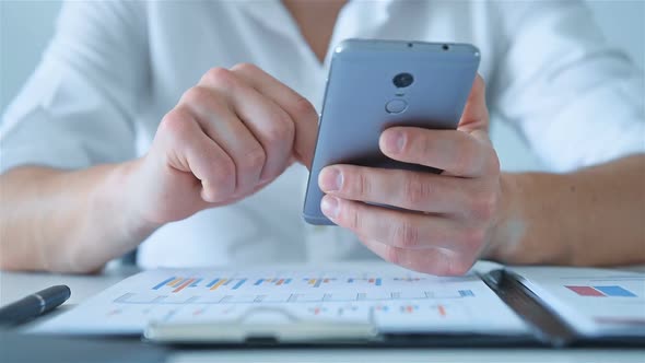 Businessman Sitting In Office And Using Mobile Smart Phone. alt