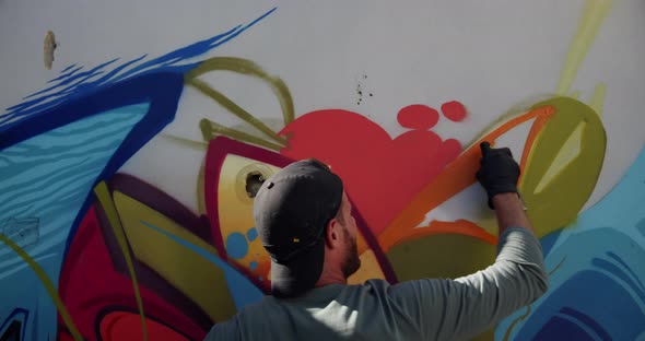 Graffiti artist painting with aerosol spray 4k alt