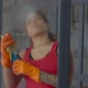Woman Cleaning Window with Rag and Detergent Spray - VideoHive Item for Sale