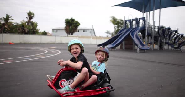 Siblings Ride A Go Kart