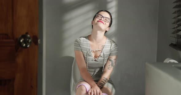 Slow Motion Woman On Toilet Smiling And Feeling Extreme Relief