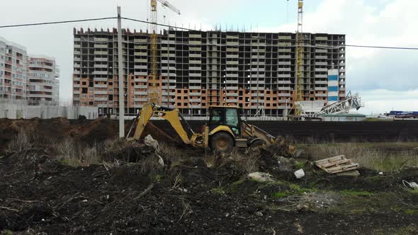 Excavator digs a trench. alt