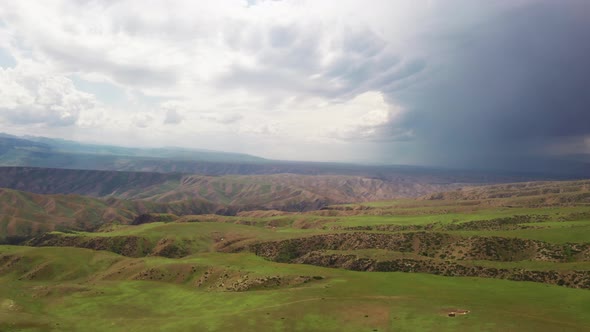 Rolling mountains under blue sky and white clouds alt