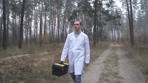In the Forest, an Ecologist Walks with a Box. Environmental Pollution Studies
