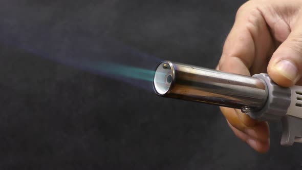 A master mechanic adjusts the flame of a gas burner.