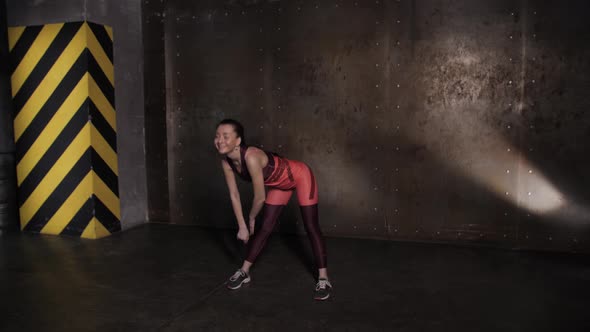 Athletic Beautiful Woman Doing Exercises in the Gym alt