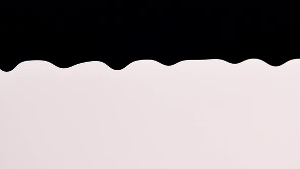 Black Paint Slowly Drips Down on White Background alt
