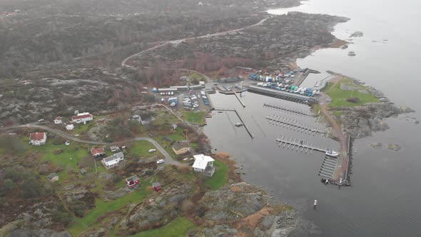 Rocky Landscape and Small Marina and Winterized Boats Aerial Circling