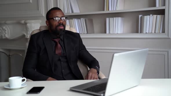 Rich Black Man Is Dressed Business Suit Is Talking By Videocall on Laptop, Chatting Online By alt