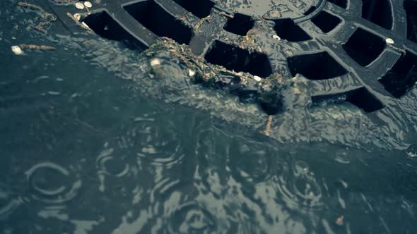 Rainwater Flows On The Road And Fall Into The Metal Hatch With Holes Drain 3