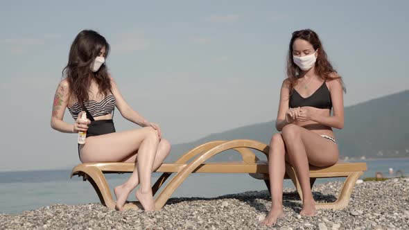 Young Attractive Girls Enjoying Beach Holidays in Bikini in Protection From Virus Infection alt