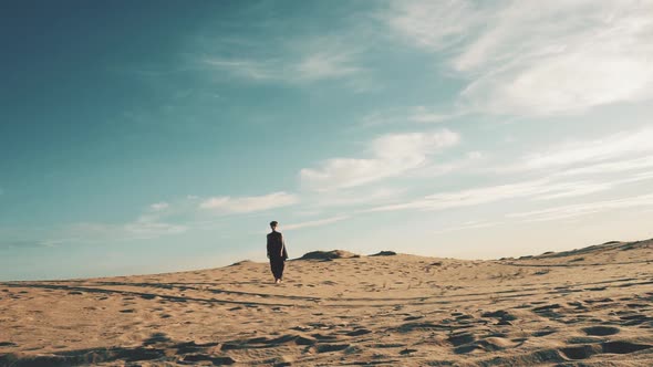 Young Beautiful Woman Walking in Desert Landscape