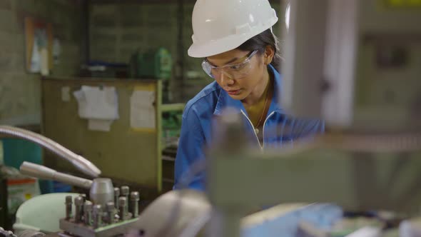candid asian female Professional engineering wearing uniform and safety goggles alt