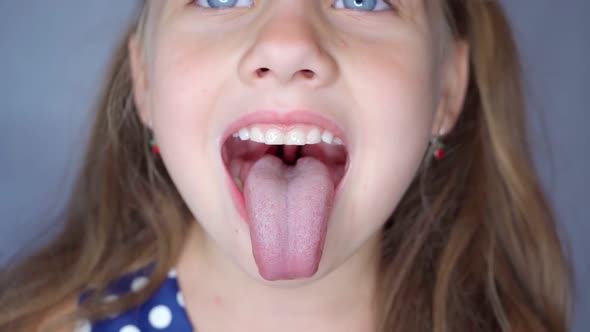 Girl Opens Her Mouth Wide and Pulls Out Long Tongue