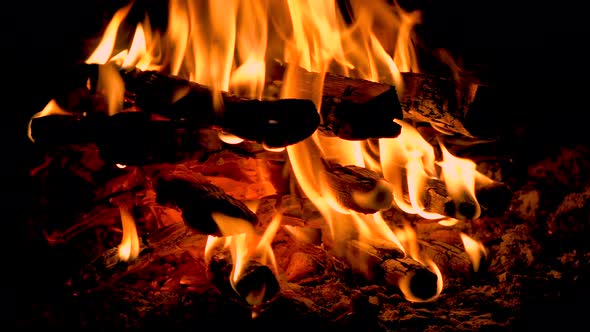 Hot fireplace full of wood. Real Flames from burning logs. Fireplace background. Fire flame close up