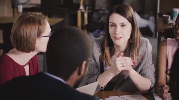 Happy Successful Businesswoman Talking To Multiethnic Colleagues at Corporate Board Meeting alt