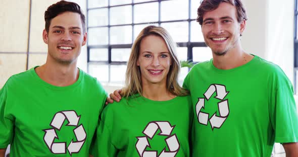 Volunteers wearing green ecologic t-shirt showing thumbs up alt