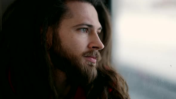 Young Handsome Man in Train Looking at Window Close Up Portrait Pensive Guy Travelling By Train alt