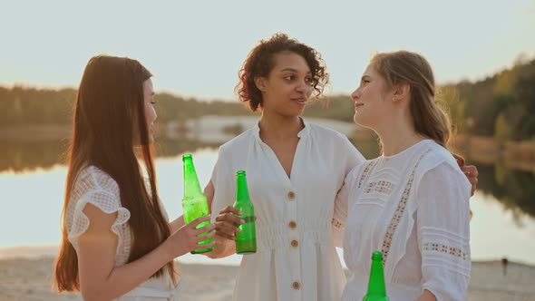 Group of Female Friends Talking and Looking at the Camera at the Beach Party