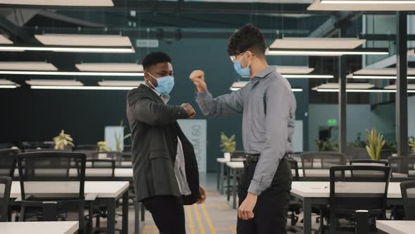 Two Colleagues Friends African Man Meet Arabian Coworker in Protective Medical Face Mask Greet alt