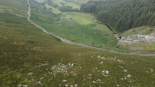 Narrow Road Along The Green Valley At The Wicklow Mountains In Ireland With Waterfall Flowing Down T alt