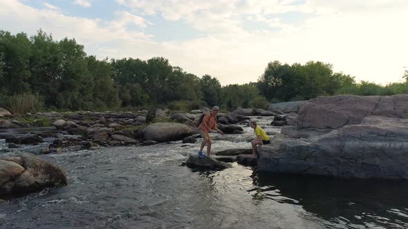 Couple Skimming Stones Across a River alt