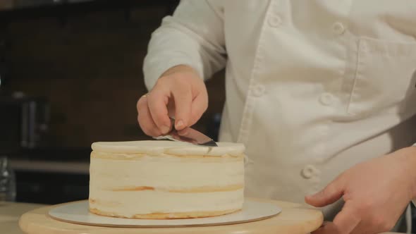 European Man Pastry Chef Is Working on a Cake Preparation Form