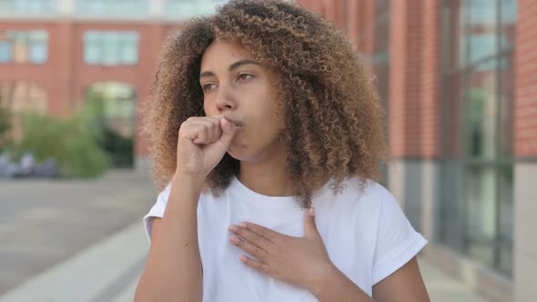 African Woman Coughing While Standing Outdoor alt