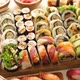 Above view of various sushi and rolls placed on wooden board. Japanese food  fest Stock Photo by Daniel_Dash