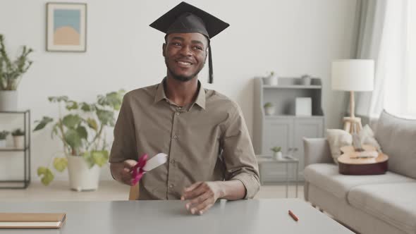 African Student Having Graduation Ceremony by Internet alt
