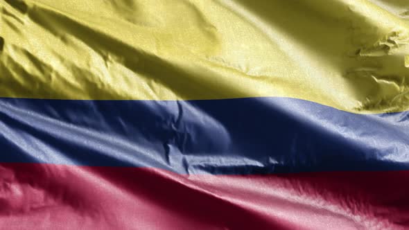 Colombia textile flag waving on the wind. Slow motion. 20 seconds loop.  alt