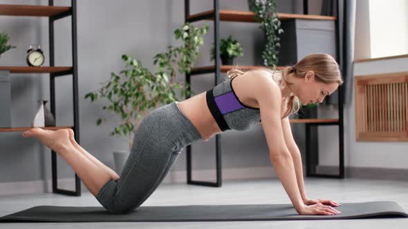 Athletic Woman Performing Push Ups on Mat Floor Home Practicing Sports Effort Morning Training alt