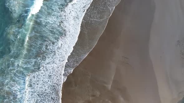 Aerial Footage of Tranquil Sea Waves on a Sandy Shore alt