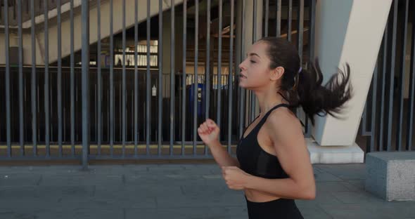 Athletic Young Woman Jogging Outdoors in Slow Motion alt