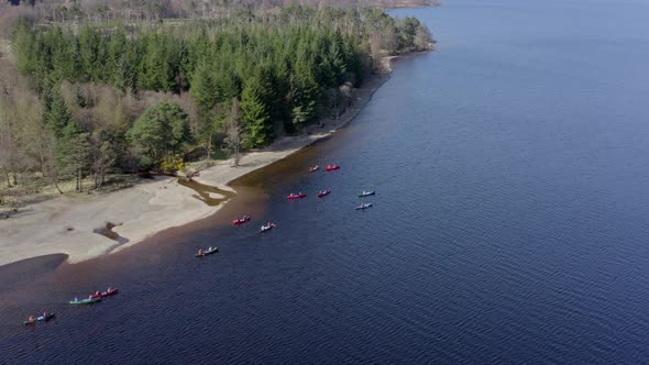 Canoeists Close to the Shore of a Lake During the Summer alt