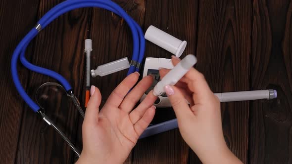 Closeup of a Woman with Diabetes Measuring Blood Sugar with a Glucometer at Home alt