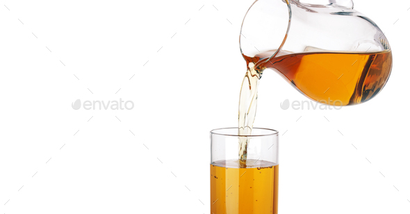 Orange juice pouring from pitcher into glass isolated on white background  Stock Photo by xamtiw