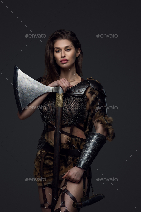 Studio shot of warlike female viking with axe