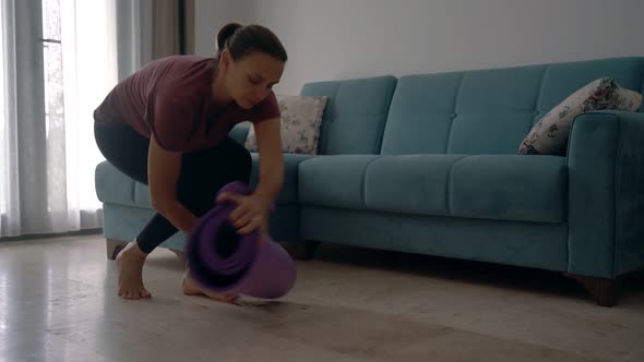 An Attractive Young Woman Preparing for Yoga and at Home. alt