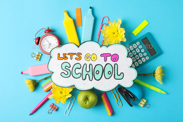 Text Let's go to school and school supplies on blue background