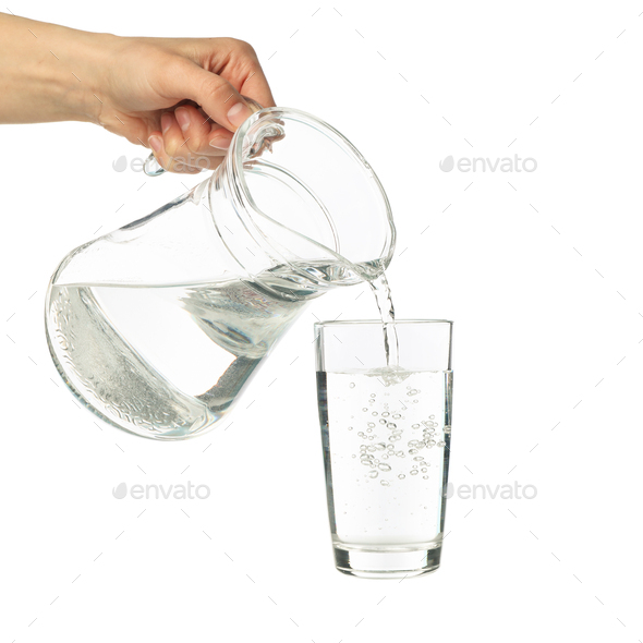 Pouring water from glass pitcher, isolated on white Stock Photo