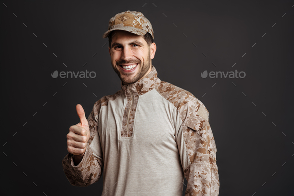 Happy masculine military man smiling and showing thumb up
