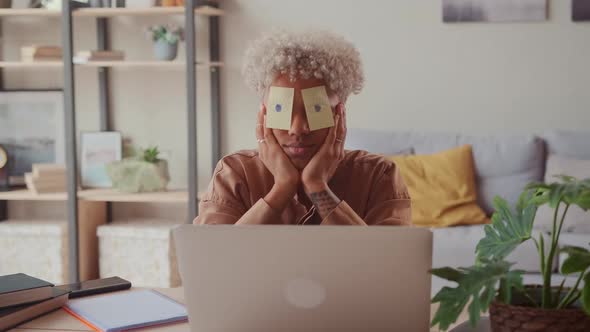 Exhausted African Employee Asleep at Workplace After Hard Working at Office alt